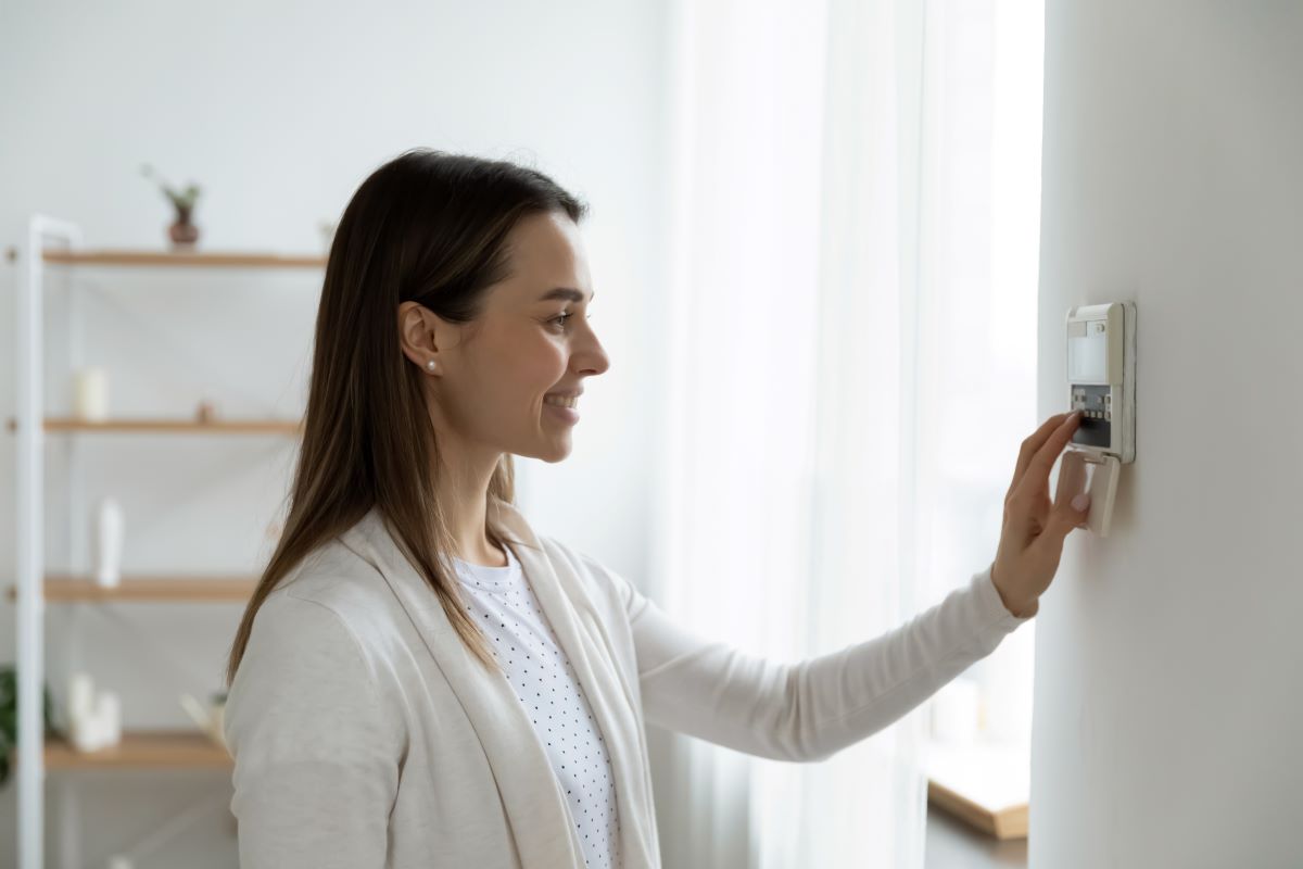 Lady touching thermostat